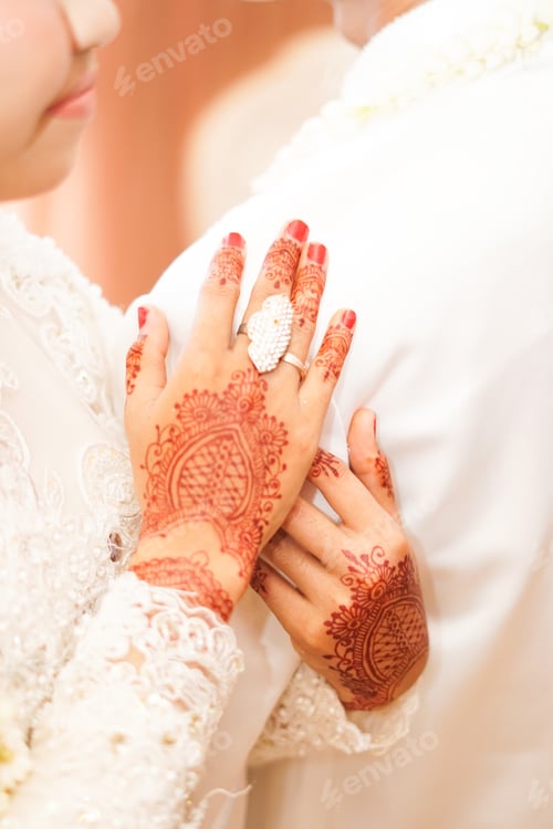 Preview: Shallow focus of traditionally designed henna tattoo on both arms of a woman