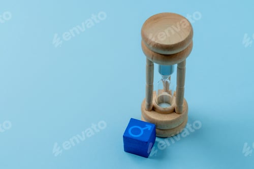 Preview: A wooden hourglass and a blue cube with the male symbol.