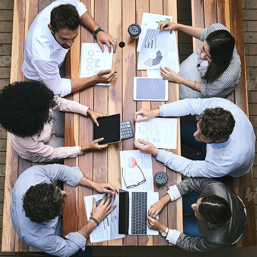 Preview: High angle shot of a team of businesspeople having a meeting outside