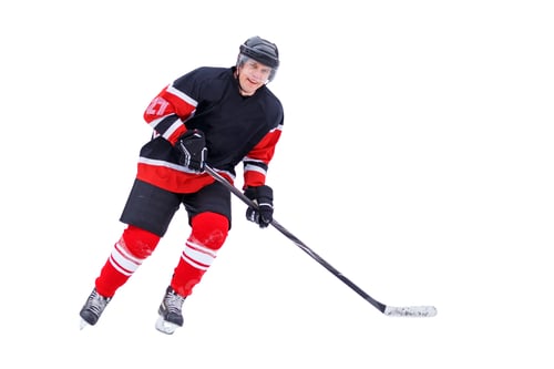 Preview: Hockey player with stick smiling into the camera isolated on white background