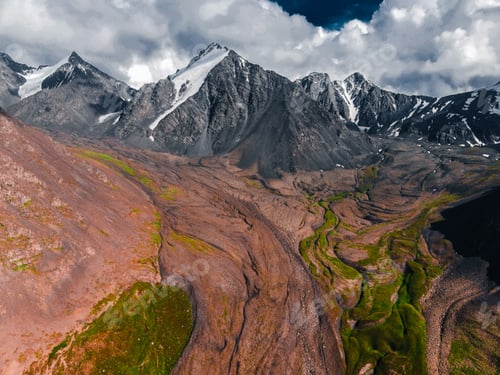Preview: Aerial view of glacial riverbed and mountain peaks