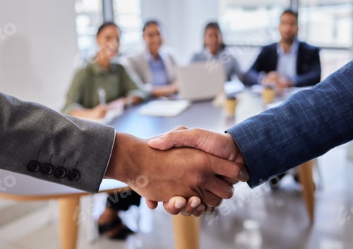 Preview: Welcome to the team. Shot of two business people shaking hands in greeting.