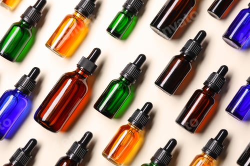 Preview: Flat lay composition with cosmetic bottles of essential oils on color background