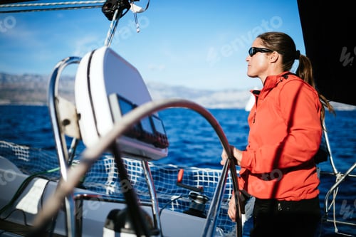 Preview: Attractive strong woman sailing with her boat