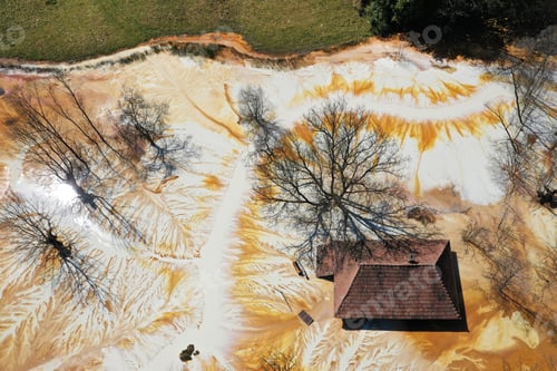 Preview: Aerial view of sinking village house in the middle of toxic mine decanting lake