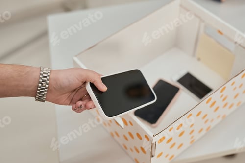 Preview: Man putting phone in box
