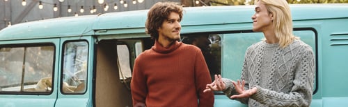 Preview: Handsome young couple enjoying a moment of connection near a vintage van in a cozy outdoor setting