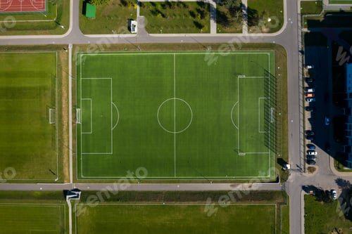 Preview: Top view of a football field with green grass outdoors in summer