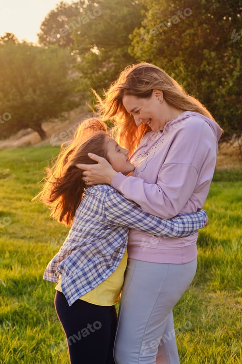 Preview: happy family mother and child daughter in nature Park in summer on green grass