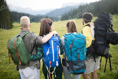 Preview: travel, tourism, hike, gesture and people concept - group of smiling friends with backpacks