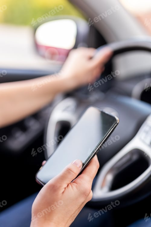 Preview: Woman driving a car and typing a text message