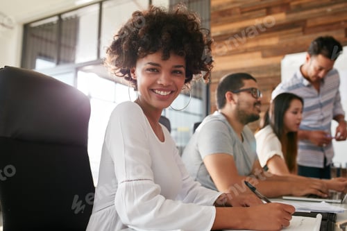 Preview: Attractive young woman sitting at conference room