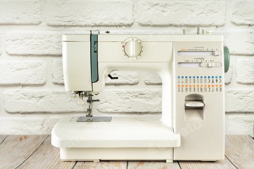 Preview: Modern sewing machine on table in tailor's workshop
