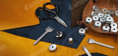 Preview: Tailor workplace. Close up view of the eco leather and tailoring equipment