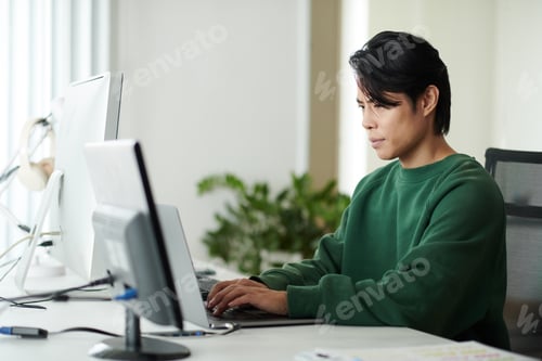 Preview: Man Coding on Laptop