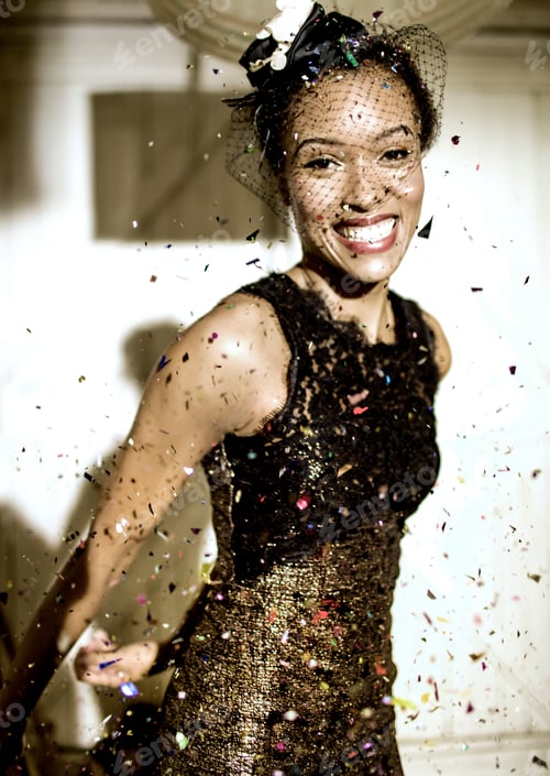 Preview: Young woman wearing a veil with confetti falling.