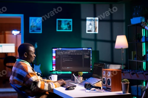 Preview: Programmer in home office concentrating on finding bugs while he codes