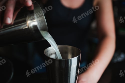 Preview: Bartender Making Cocktail with Shaker and Metal Cup