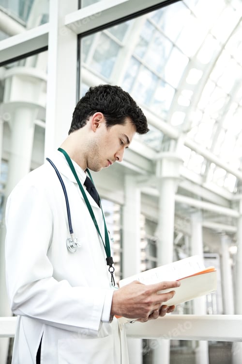 Preview: Caucasian man doctor going over a patient history.