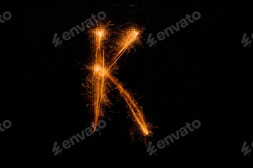 Preview: The English Letter K Made Of Sparklers On Black Background