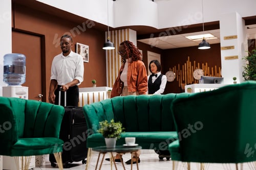 Preview: Couple sitting in lounge area at hotel