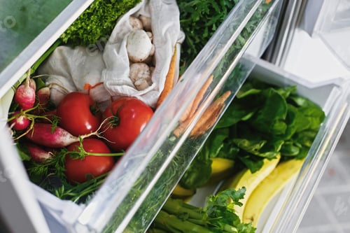 Vista previa: Zero waste grocery in fridge. Fresh vegetables in opened drawer in refrigerator
