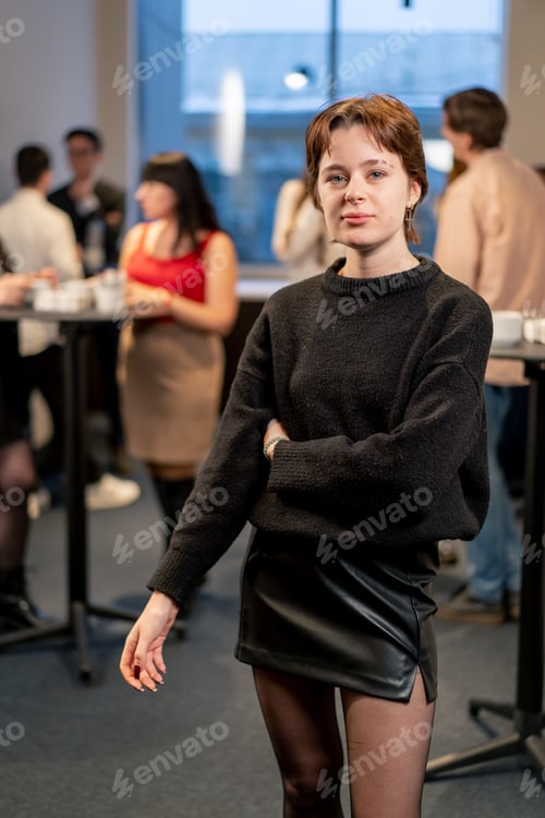 Preview: portrait of a young girl at a business conference during a coffee break working networking