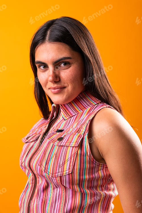 Preview: Confident young woman posing against vibrant background