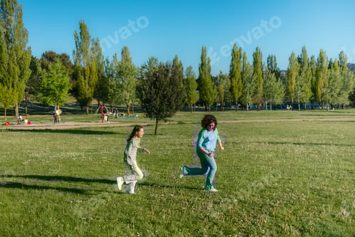 Preview: Happy family enjoying a sunny day at the park, running and playing on the grass
