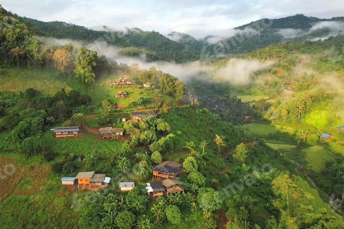Preview: Aerial view from drone of the rural village in the mountains on foggy day
