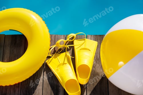 Preview: Fippers and goggles on wooden planks near swimming pool