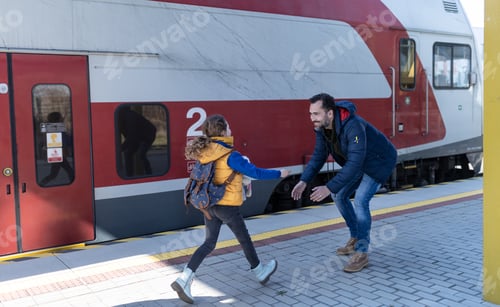 Preview: Happy Ukrainian refugee girl running to her father waiting at railway station, reunion after war.