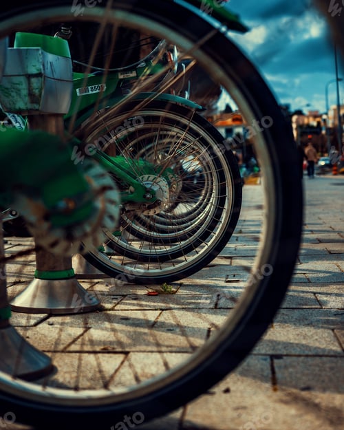 Preview: Vertical closeup shot of the wheels of a row of bikes on a rack