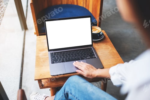 Preview: a businesswoman using and touching on laptop touchpad with blank white desktop screen