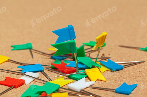 Preview: Mini flags thumbtacks over corkboard background close up