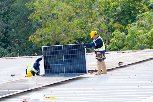 Preview: workers installing solar panels, for efficient energy on rooftop