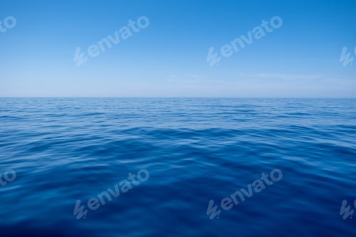 Preview: Sea water surface calm with small ripples, deep blue color and blue sky background,