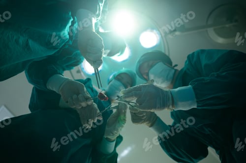 Preview: Medical team of surgeons in hospital doing invasive surgical interventions