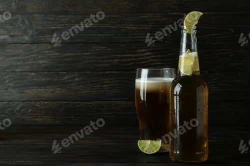 Preview: Beer with lime on wooden background, space for text