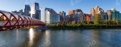Preview: Peace Bridge across Bow River during a vibrant summer sunrise