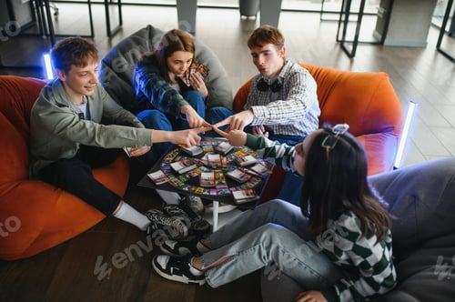 Preview: Teenagers playing board game and having fun together