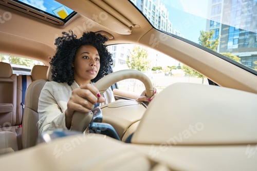 Preview: Pretty mixed race woman driving a car