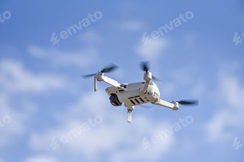 Preview: Drone DJI Mavic Mini 2 flying in air, blue sky on background