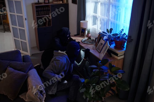 Preview: Two Men Wearing Masks Searching Drawer near Window
