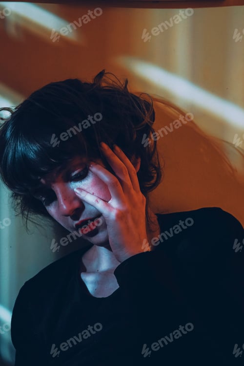 Preview: Artistic portrit of a young woman posing and crossed by ligths
