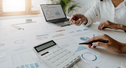 Preview: Business team analyzing income charts and graphs with modern laptop computer. Close up.Business