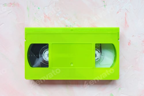 Preview: Green vintage VHS video tape on pink background