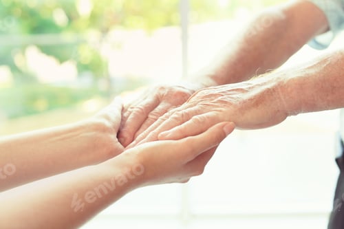 Preview: Helping hands on blurred background, closeup. Elderly care concept