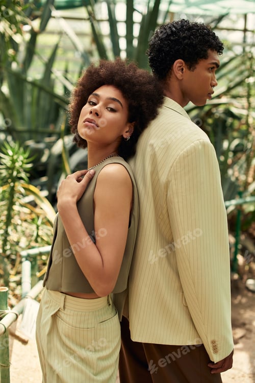 Preview: Young couple embracing love amidst lush greenery in a vibrant greenhouse setting