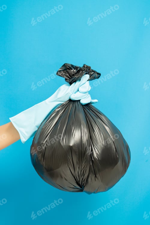 Preview: Cleaner concept, Hand in rubber gloves and holding plastic bag with trash waste